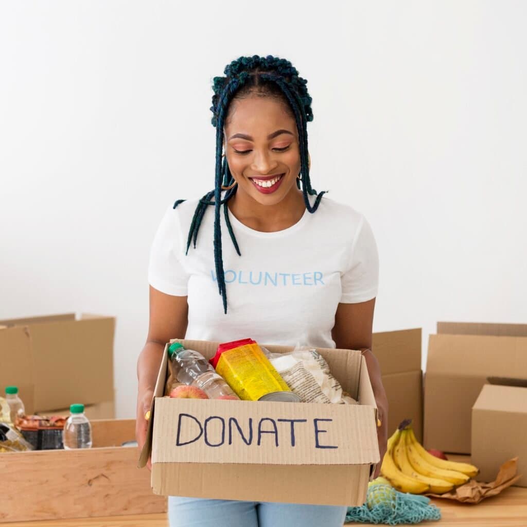 Smiley woman holding donation box
